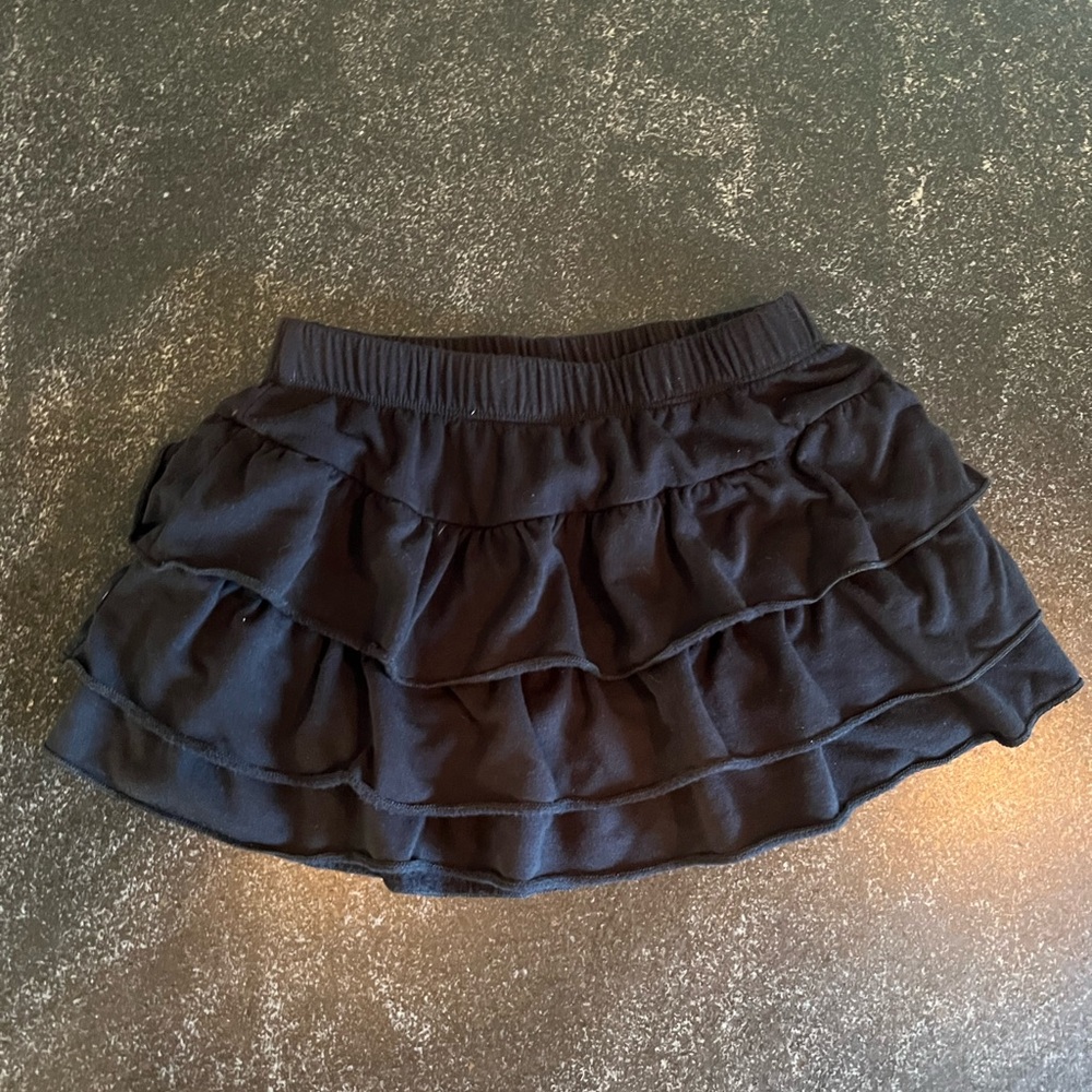 Black ruffled tiered Pixie Lane skirt. Size 8